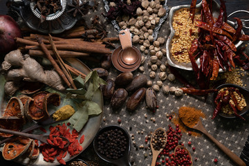 Spices and herbs on old kitchen table.