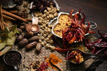 Spices and herbs on old kitchen table.