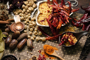 Spices and herbs on old kitchen table.