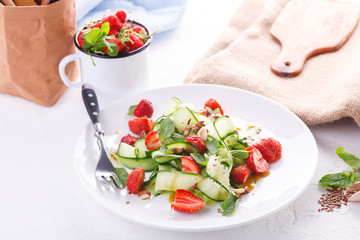 light summer detox salad with strawberries, cucumber, nuts and flax seeds