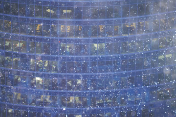 city lights snow glow background blurred / cityscape blurred bokeh, snowy weather seasonal background winter December