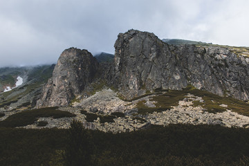 Two rocks standing as guardians watching over upland overlooking the mountains.