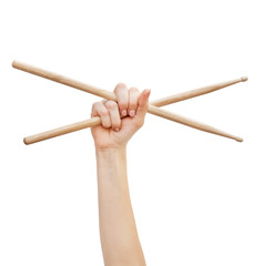Woman's hand holding drum sticks isolated on white background.