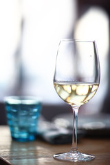 glass of white wine in the restaurant / white wine in the interior of the restaurant a table with glasses of wine, a romantic summer