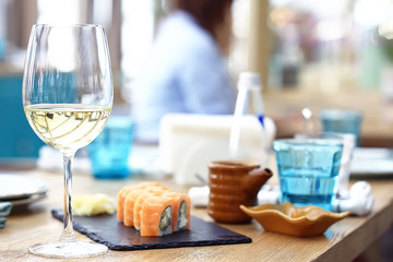 glass of white wine in the restaurant / white wine in the interior of the restaurant a table with...