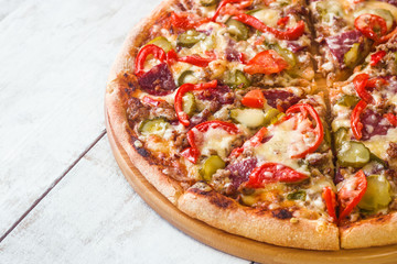 homemade pizza on white wooden background close up