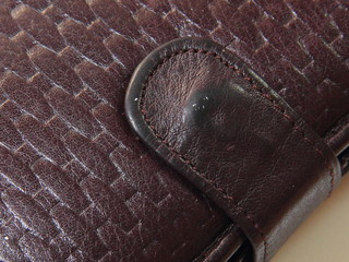Flap leather brown purse frayed with scuffs