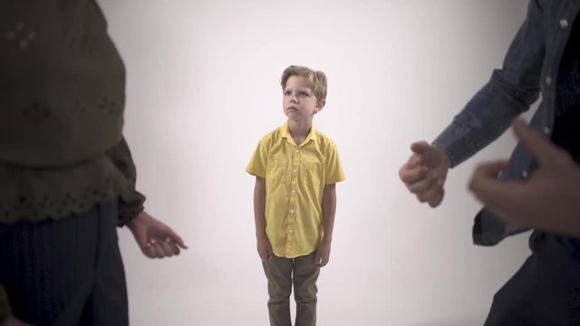 Domestic Violence and Family Conflict Concepts. Sad little boy watches parents quarrel in front.  Dysfunctional family. Slow motion