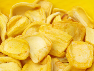 Close up of a pile of dried jackfruit chips isolated on white background