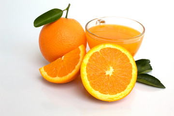 glass of orange juice and oranges isolated on white background