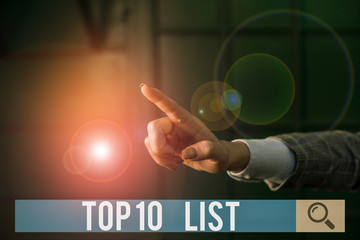 Conceptual hand writing showing Top 10 List. Concept meaning the ten most important or successful items in a particular list Finger pointing in the Dark with hand pointing in the copy space