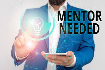 Writing note showing Mentor Needed. Business concept for wanted help for more experienced or more...