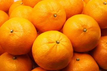 Above or top view of pile of orange fruit background from the market which beautiful, fresh and organic  