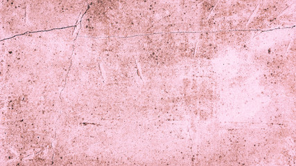 Concrete grunge background in pink - beautiful contrasting texture of a cement surface with cracks in a dirty pink color