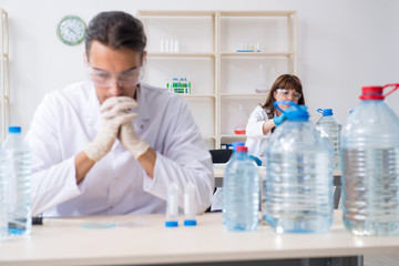 Two chemists working in the lab