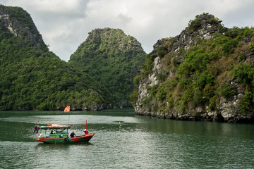 Fototapeta na wymiar Fishing boats among the islands that make up Ha Long Bay, Vietnam.