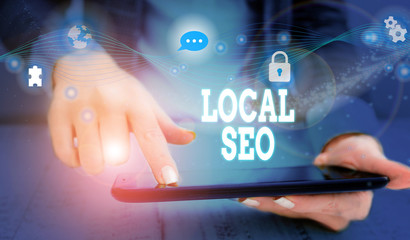 Writing note showing Local Seo. Business concept for helps businesses promote products and services to local customers Picture photo network scheme with modern smart device