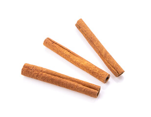 cinnamon sticks stacked on white background