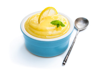 Homemade Lemon Curd in blue ceramic bowl isolated on white