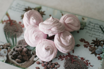 Homemade pink marshmallow on glass chopping Board close up