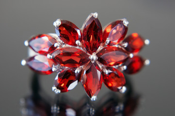 beautiful vintage ring with garnet stones as flower on black background