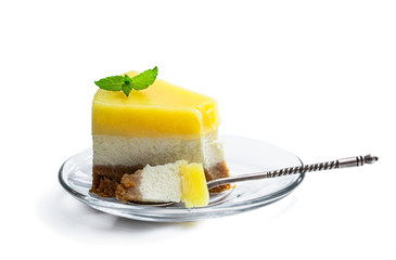 Slice of homemade lemon cheesecake isolated on white