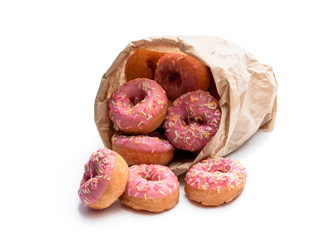 Mini pink glazed doughnuts in paper bag isolated on white