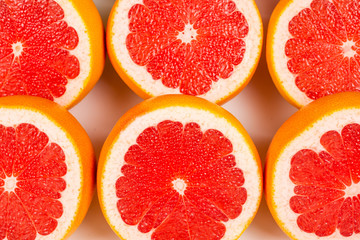 Fototapeta na wymiar Grapefruit red juicy slices background. top view