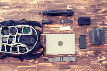 Being ready for a trip as a professinal photographer with accessories on a wooden backgraund