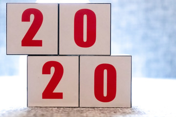 Abstract 2020 & 2019 New year countdown design concept - woman holding wood blocks cubes on wooden...