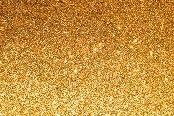 shine and sparkle of golden glitter abstract background	