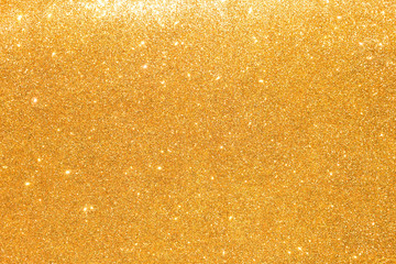 shine and sparkle of golden glitter abstract background	