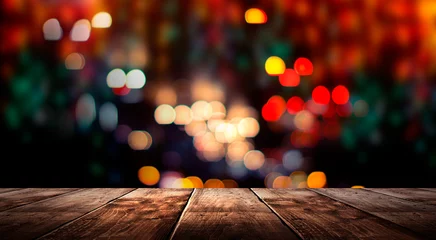 Foto op Plexiglas Wooden table, blurred bokeh background background. Neon light, night view, close-up. The general background of the interior, a dark background. © MiaStendal