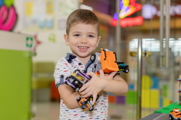 Children play with educational toys. Children sit on the carpet in the playroom at home or in the kindergarten.boy with toy cars