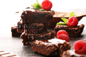 chocolate brownie cake dessert with raspberries and spices on a wooden background.
