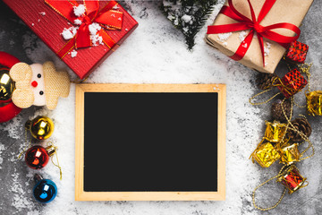 Gift boxs with christmas tree, balls and chalkboard for your greetings on fake snow