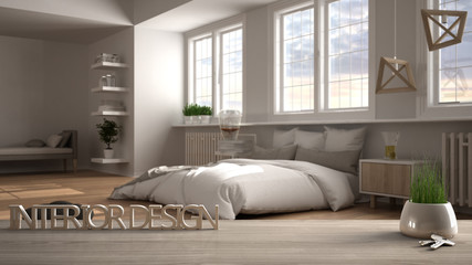 Wooden table, desk, shelf with potted grass plant, house keys and 3D letters making the words interior design, over modern bedroom with bed, project concept copy space background