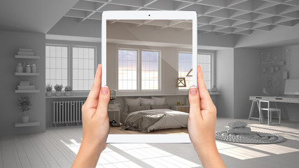 Hands holding tablet showing modern bedroom with bed, total blank project background, augmented...
