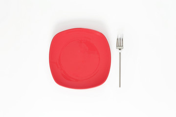 Empty Red color plate and fork next to it. Isolated object - on white background