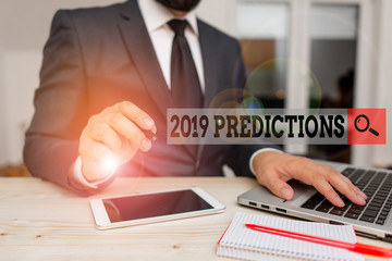 Conceptual hand writing showing 2019 Predictions. Concept meaning statement about what you think will happen in 2019 Male human wear formal clothes present use hitech smartphone