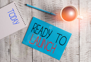 Writing note showing Ready To Launch. Business concept for an event to celebrate or introduce something new to market Stationary placed next to a cup of black coffee above the wooden table