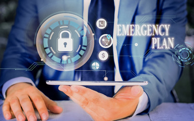 Writing note showing Emergency Plan. Business concept for procedures for handling sudden or...