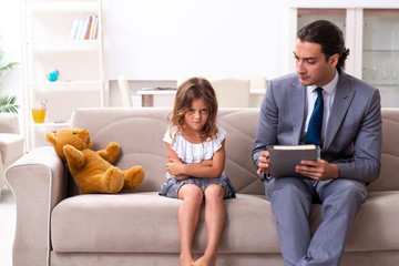 Child psychologist attending small girl