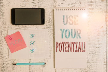 Writing note showing Use Your Potential. Business concept for achieve as much natural ability makes possible Square spiral notebook marker smartphone sticky note on wood background
