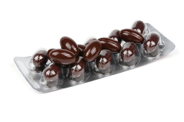 Brown tablets on white background.