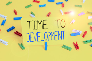 Text sign showing Time To Development. Business photo text a length of time during which a company grows or develop Colored clothespin papers empty reminder yellow floor background office