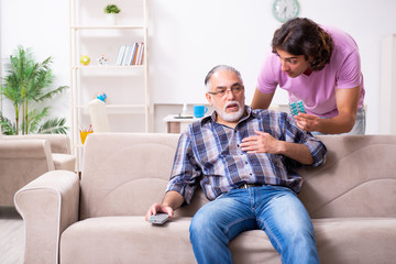 Young student and his old grandpa at home