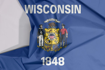 Wisconsin fabric flag crepe and crease with white space. Coat of arms on dark blue field with the...