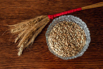 composition of a vase with seeds, twigs twisted on the table.