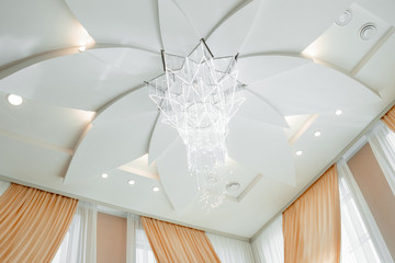 composition of an interesting apartment interior. ceiling with a chandelier